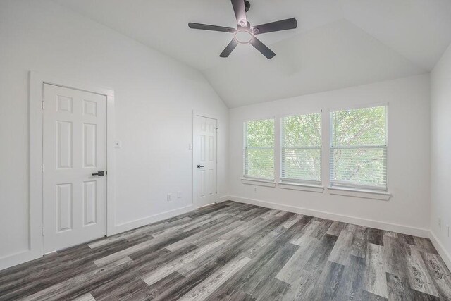 empty room featuring ceiling fan, vaulted ceiling, and hardwood / wood-style flooring