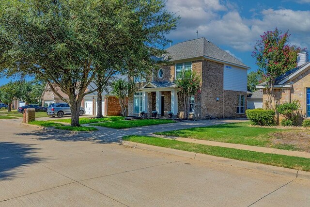 view of front of house with a garage and a front lawn