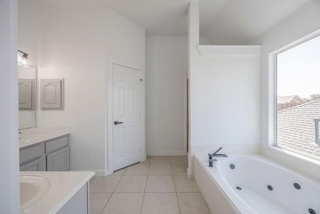 bathroom with tile patterned floors, vanity, and a bath