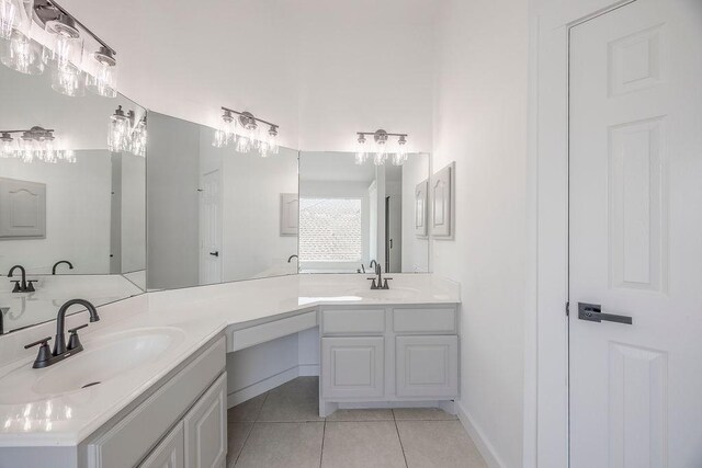 bathroom with tile patterned floors and dual vanity