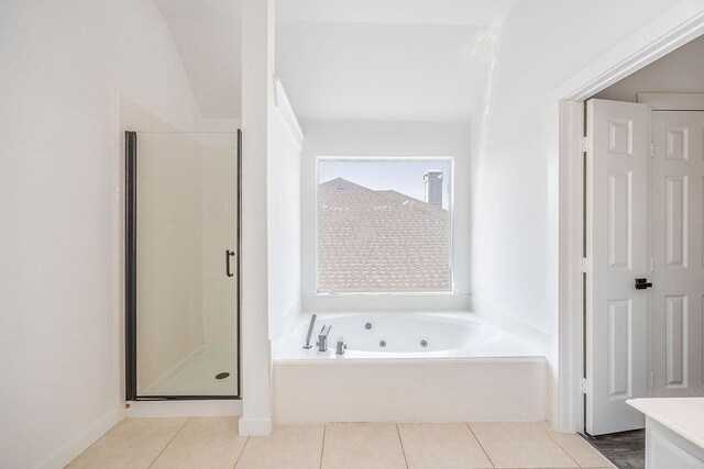 bathroom featuring tile patterned flooring and separate shower and tub