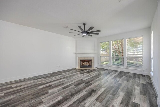 unfurnished living room featuring hardwood / wood-style floors, a fireplace, and ceiling fan