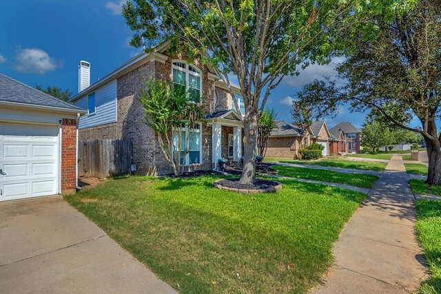 view of front of home featuring a front lawn and a garage