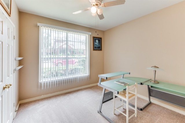 office featuring ceiling fan, light colored carpet, and plenty of natural light