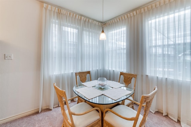 dining space featuring light carpet