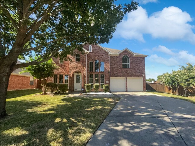 view of front of house with a garage and a front lawn