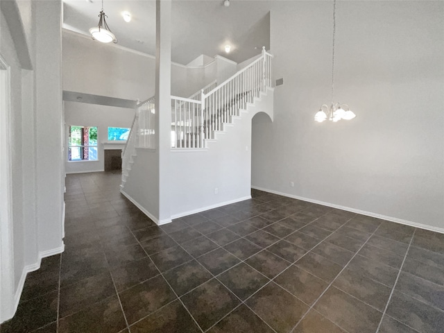 interior space featuring a high ceiling and a chandelier