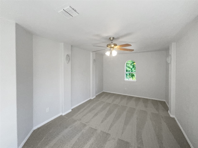 carpeted spare room featuring ceiling fan