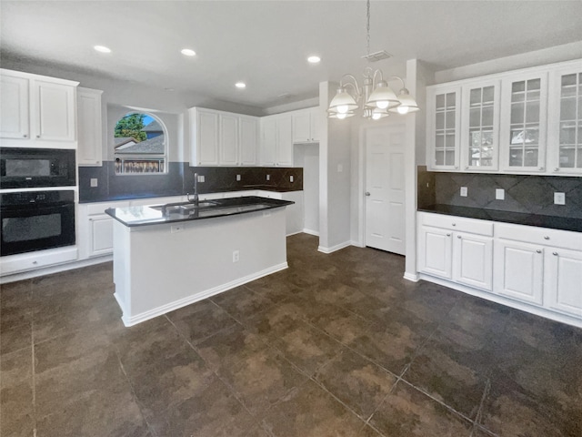 kitchen featuring sink, dark tile patterned flooring, black appliances, and white cabinets