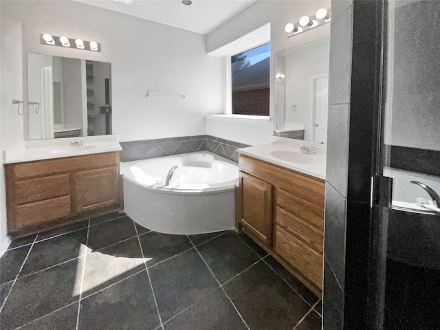 bathroom with dual vanity, a tub to relax in, and tile patterned floors