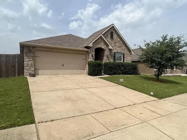 view of front of home featuring a garage and a front yard