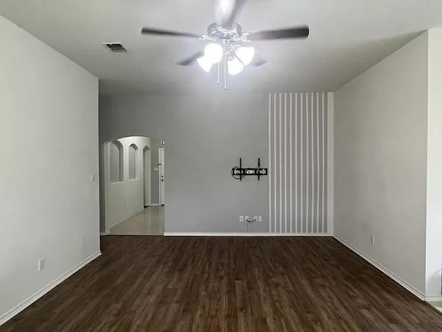 unfurnished room featuring dark hardwood / wood-style flooring and ceiling fan