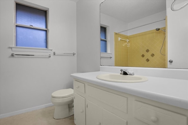 bathroom featuring vanity, a textured ceiling, and toilet