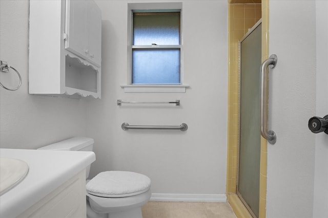 bathroom featuring tile patterned floors, vanity, an enclosed shower, and toilet