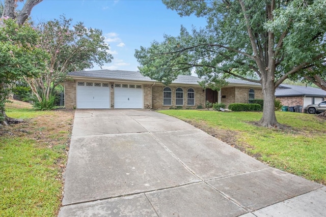 ranch-style house with a garage and a front yard