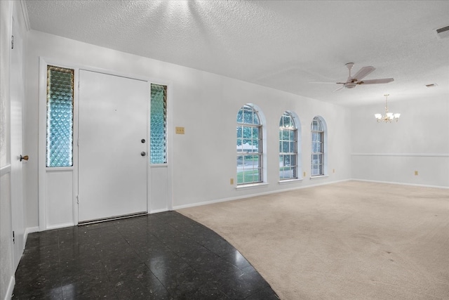 entryway with a textured ceiling, ceiling fan with notable chandelier, and carpet flooring