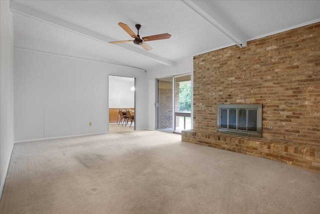 unfurnished living room featuring lofted ceiling with beams, a fireplace, carpet, brick wall, and ceiling fan