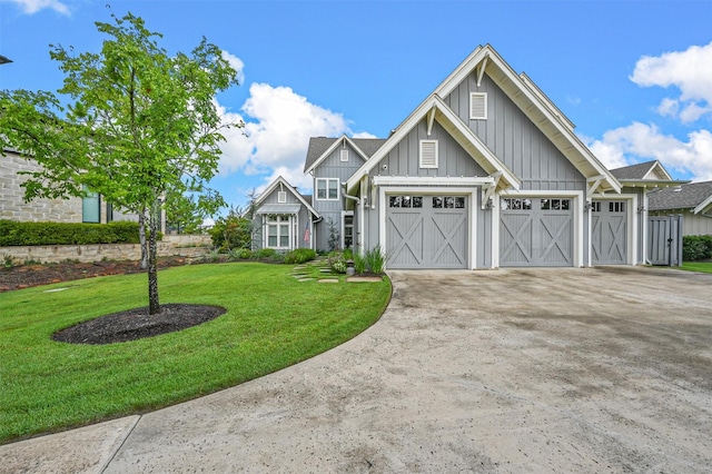 view of front of home with an attached garage, a front lawn, board and batten siding, and concrete driveway