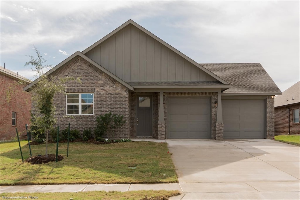 view of front of house with a front yard and a garage