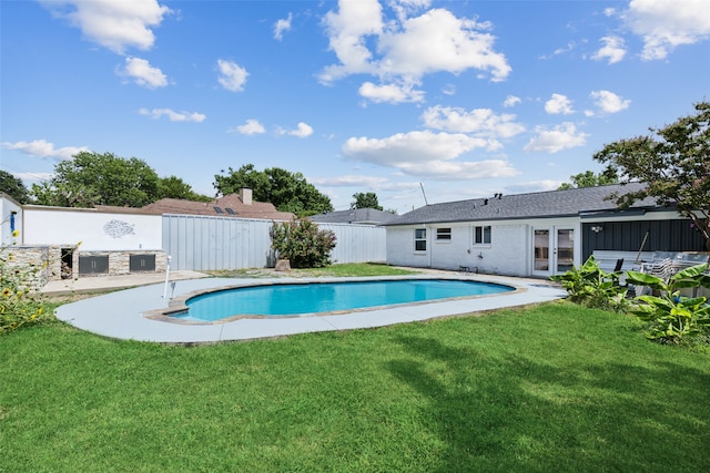 view of pool featuring a lawn and a patio