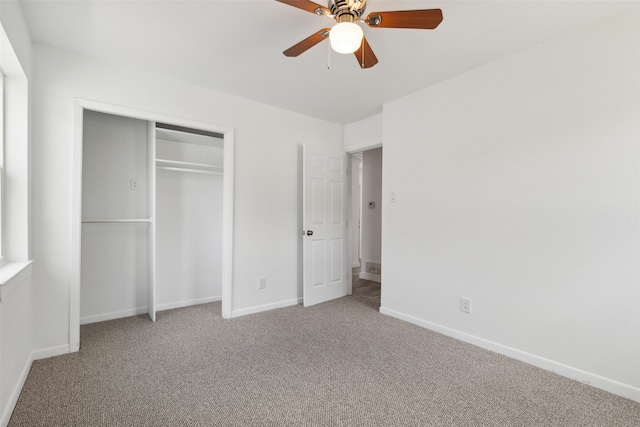 unfurnished bedroom featuring ceiling fan, a closet, and carpet floors