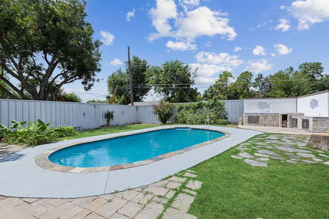 view of pool with a lawn and a patio area