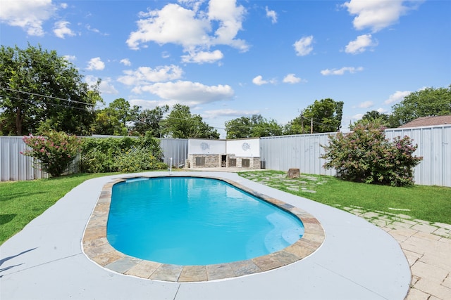 view of pool with a lawn