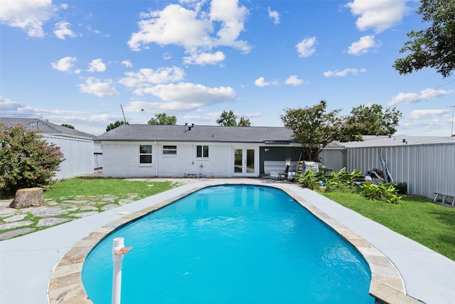 view of swimming pool with a lawn, a patio area, and french doors