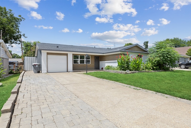 ranch-style house featuring a front yard and a garage