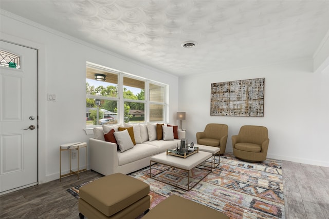 living room featuring wood-type flooring and ornamental molding