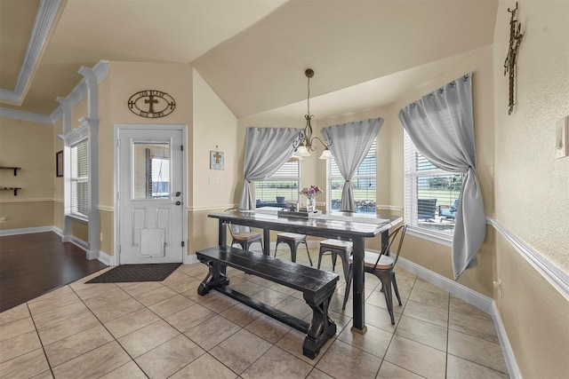 dining room featuring ornamental molding, light wood-type flooring, and a notable chandelier