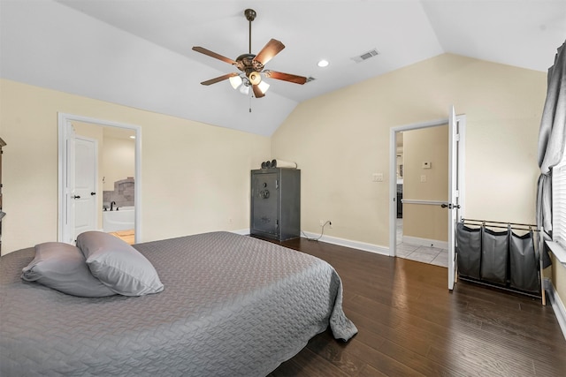 bedroom featuring ceiling fan, connected bathroom, hardwood / wood-style flooring, and lofted ceiling