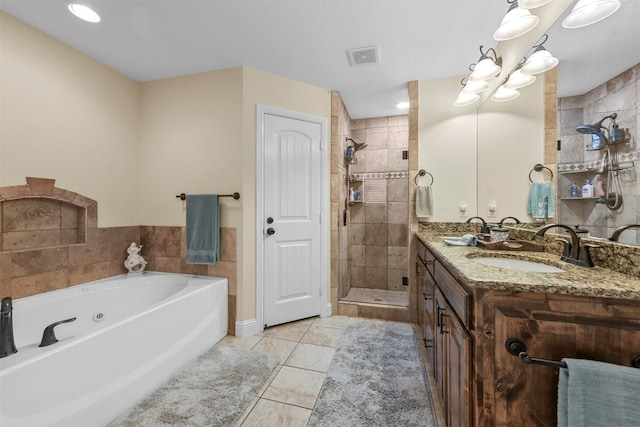 bathroom with vanity, independent shower and bath, and tile patterned flooring