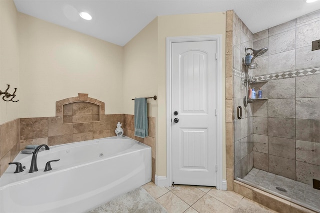 bathroom featuring tile patterned flooring and separate shower and tub