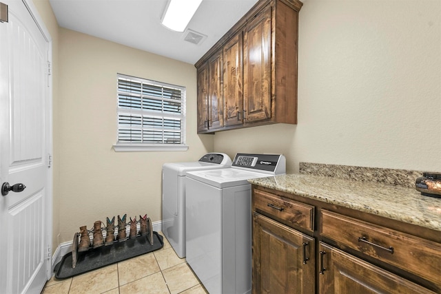 laundry area with cabinets, washer and clothes dryer, and light tile patterned floors