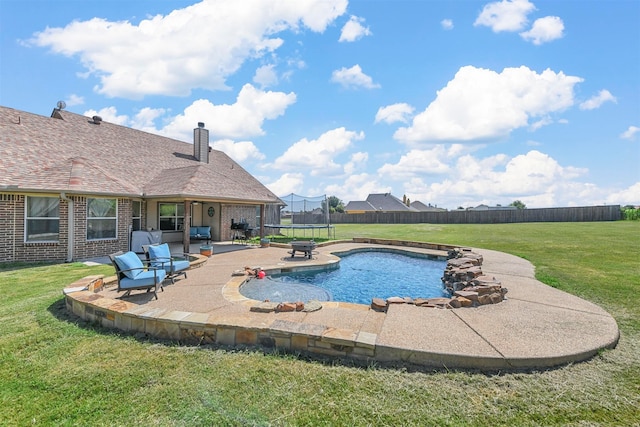 view of swimming pool featuring a patio area, a lawn, and a trampoline