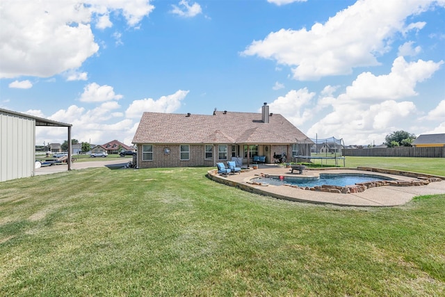 back of house with a patio, a lawn, and a fenced in pool