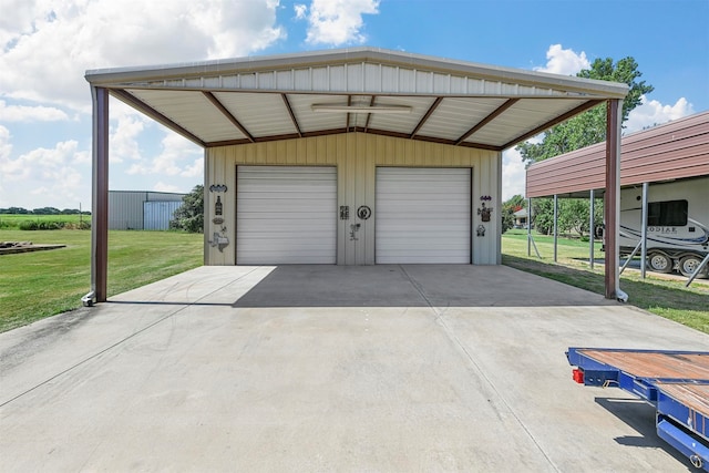 garage featuring a carport and a lawn