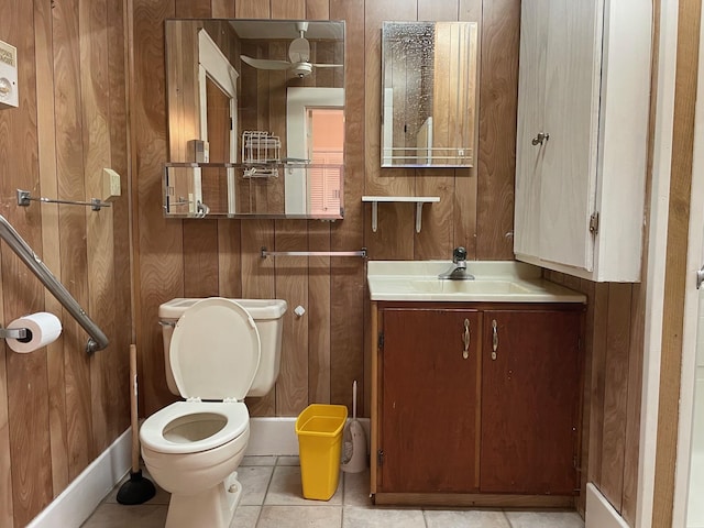 bathroom featuring vanity, tile patterned floors, toilet, and wood walls