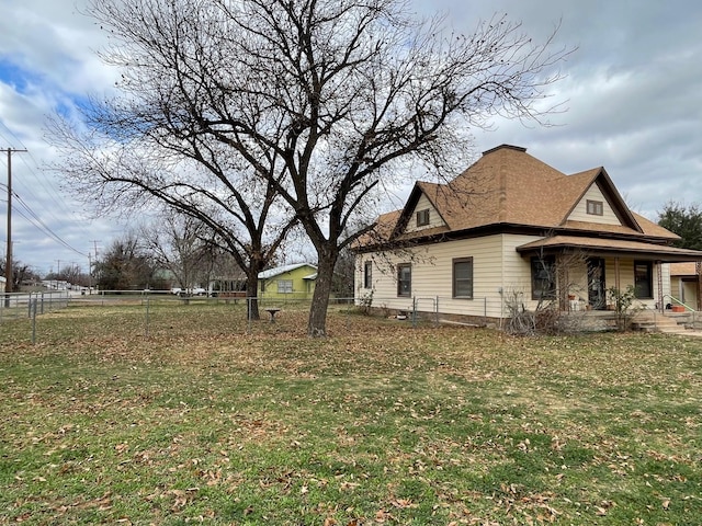 view of home's exterior with a porch and a lawn