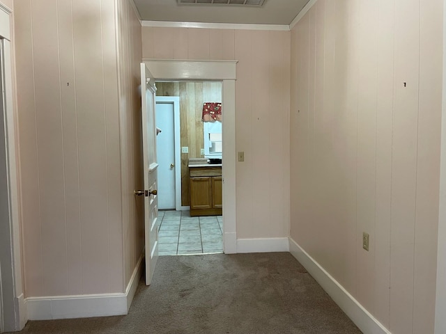 hall with light carpet and wooden walls