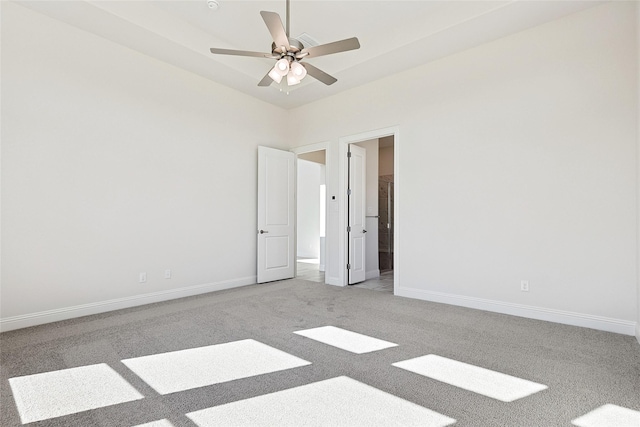 empty room featuring light carpet, ceiling fan, and baseboards