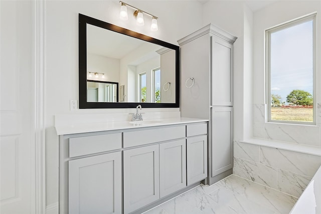 bathroom with marble finish floor and vanity