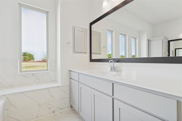 bathroom featuring marble finish floor and vanity