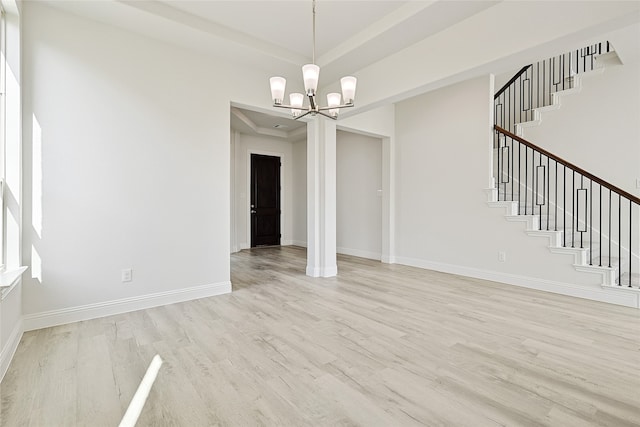 interior space featuring light hardwood / wood-style flooring and a notable chandelier