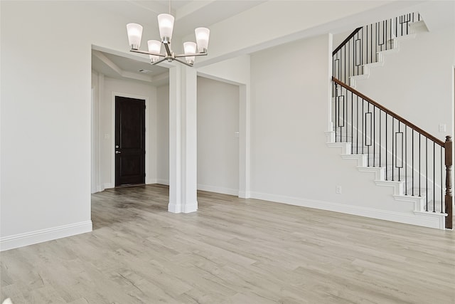 interior space featuring light hardwood / wood-style floors and a notable chandelier