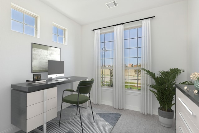 office featuring light carpet, plenty of natural light, visible vents, and baseboards