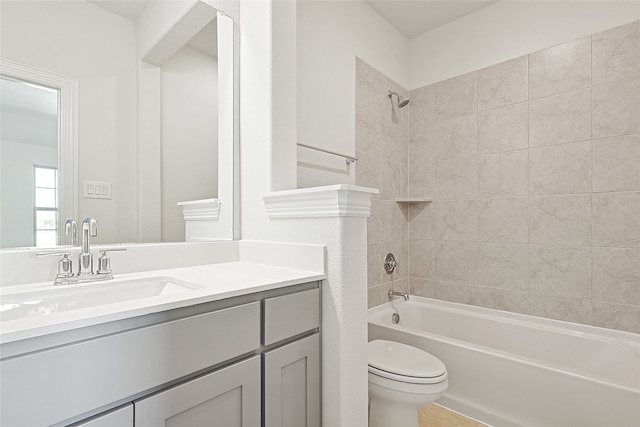 full bathroom featuring vanity, toilet, and tiled shower / bath combo