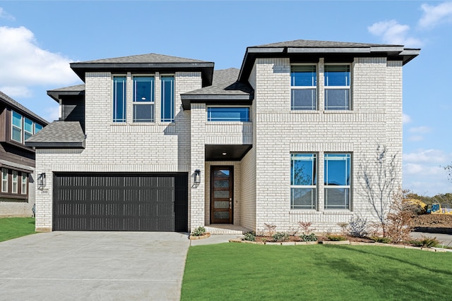 view of front of house with a garage and a front yard