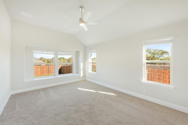 empty room featuring carpet, ceiling fan, and lofted ceiling